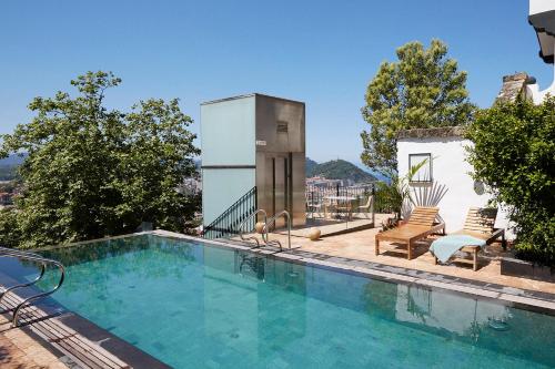 a swimming pool on top of a house at Boutique Hotel Mendi Argia in San Sebastián