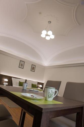 a coffee cup sitting on a table in a restaurant at Mecset Apartman in Eger