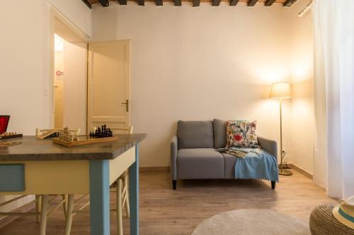 a living room with a couch and a chair at Il Cuore di Chiusi - Autentica Casa in Toscana in Chiusi