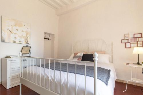 a white bedroom with a white bed and a white dresser at Authentic Home in Tuscany - Il Cuore di Chiusi in Chiusi
