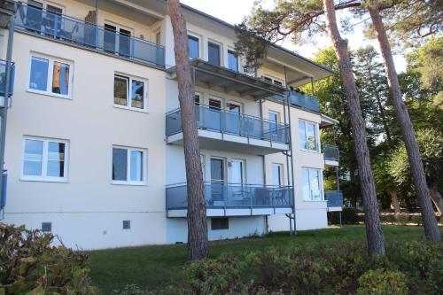 un condominio con balconi e alberi di Ferienwohnung Schwanenwiek a Lubmin