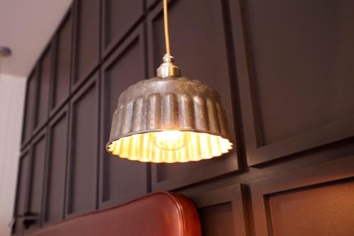 a metal pendant light hanging from a wall at Hotel Indigo York by IHG in York