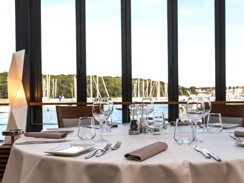 a table with wine glasses and napkins on it at Ribarska Koliba Resort in Pula