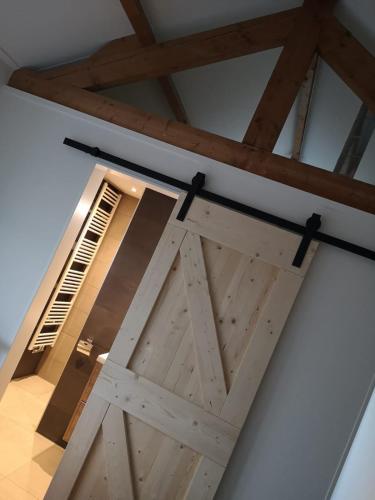 a barn door in a room with a window at Studio Zwin 9 in Zoutelande