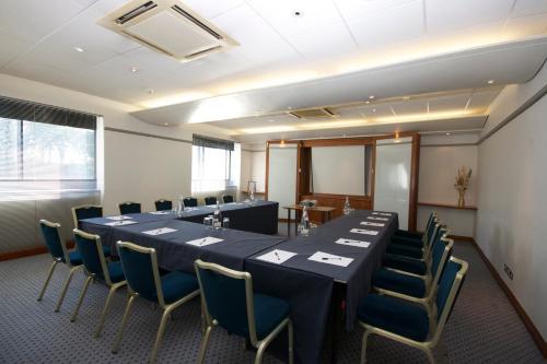 a conference room with a long table and chairs at Best Western Ipswich Hotel in Ipswich