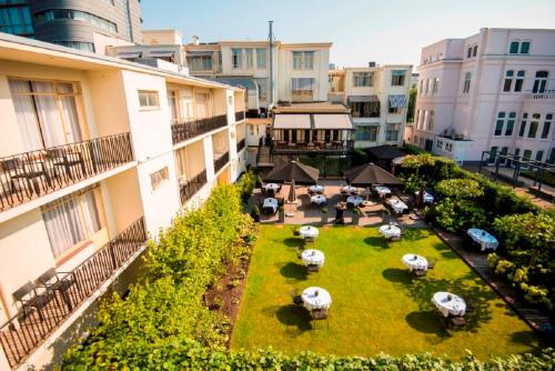 an overhead view of a courtyard with tables and umbrellas at Bilderberg Parkhotel Rotterdam in Rotterdam