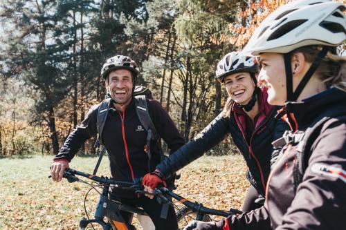 a group of three people on a bike at Hotel Rudolf in Brunico