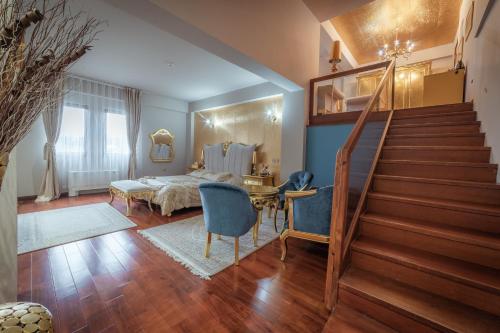 a bedroom with a staircase and a table and chairs at Bushi Resort & SPA in Skopje