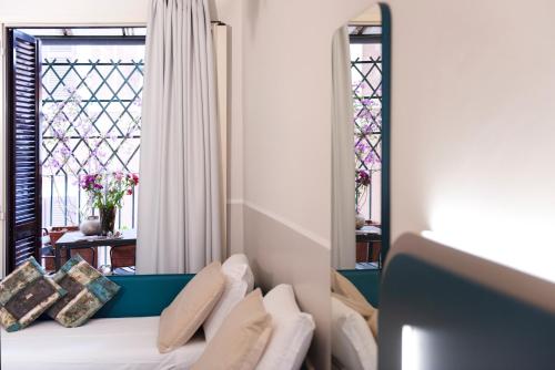 Postel nebo postele na pokoji v ubytování Hotel Grifo