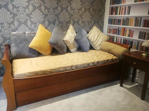 a couch with pillows on it in a living room at Haydn House in Glastonbury