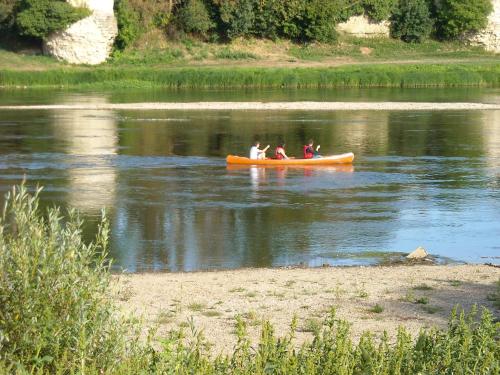 a group of people in a canoe on a river at Camping de Marcilly sur Vienne in Marcilly-sur-Vienne