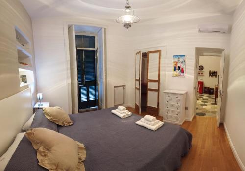 a bedroom with a bed with two towels on it at Casa Tilde Bacoli in Bacoli