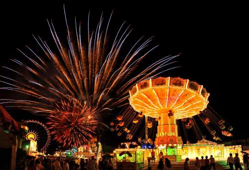 a group of ferris wheel and fireworks at a carnival at Hotel & Gasthaus DAS RÖHRL Straubing in Straubing