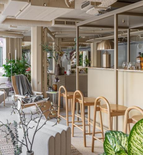 a living room with a table and chairs at Locke at Broken Wharf in London