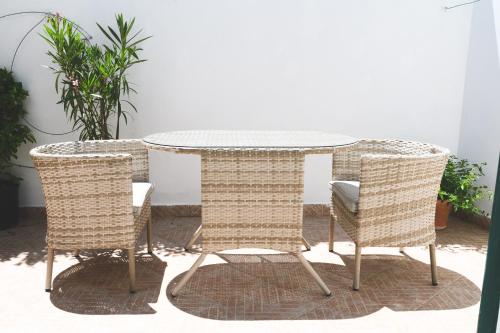 a rattan table and two wicker chairs around a table at Parco Augusto in Capri