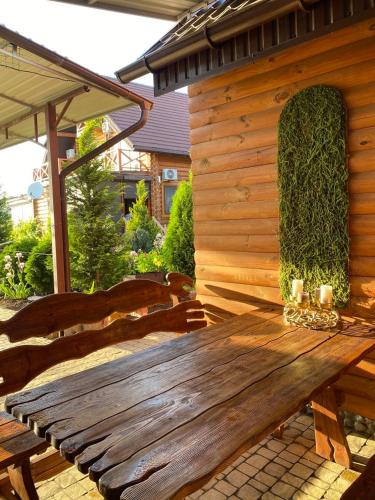 a wooden bench sitting outside of a cabin at Villa Camilla, Затока in Zatoka