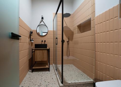 a bathroom with a shower with a mirror and a sink at Nest in Győr