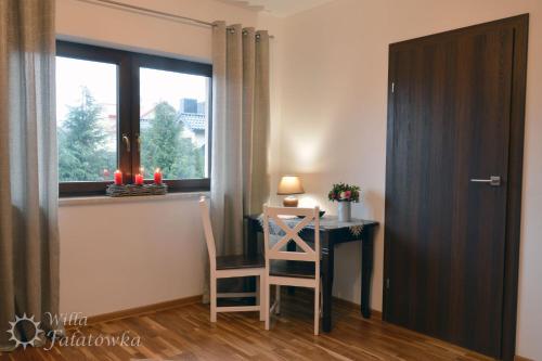 a room with a desk and a chair and a window at Willa Fałatówka Mielenko - Mielno Wczasy nad morzem in Mielenko