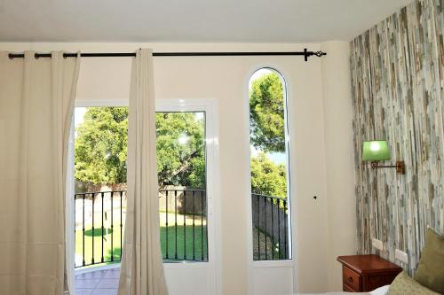 a room with a window and a door with a view at Hotel La Fuentecilla in Algatocín