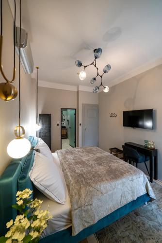 a bedroom with a large bed and a desk at Nest in Győr