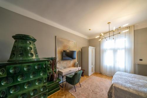 a bedroom with a green dresser with a bed and a desk at Nest in Győr
