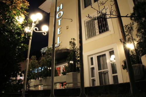 a building with a sign in front of it at night at Hotel Vila Tina in Zagreb
