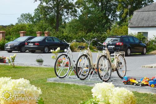 a group of bikes parked in a parking lot at Willa Fałatówka Mielenko - Mielno Wczasy nad morzem in Mielenko