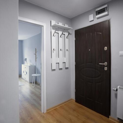 a room with a black door and a white wall at Mieszkanie w Kamienicy in Pasłęk