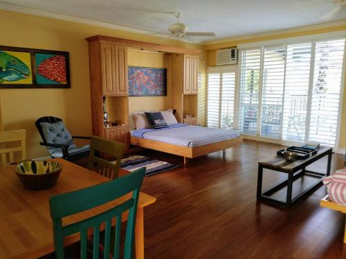a living room with a bed and a table at Beach Getaway III at Belleview in Clearwater Beach