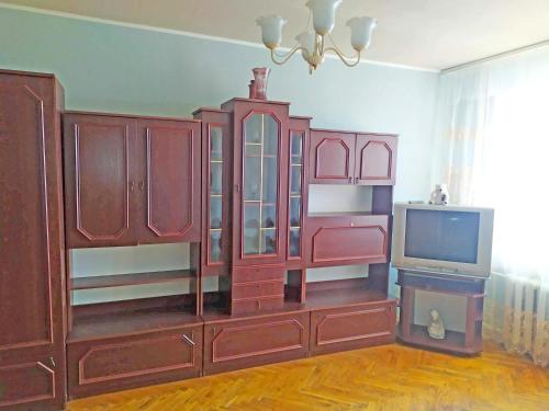 a living room with a entertainment center and a tv at Malishko in Kyiv