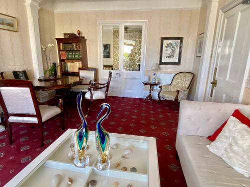 a living room with a tub with two swans on it at St. Georges House in Shanklin