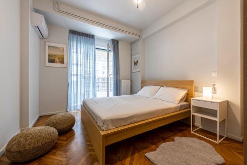 En eller flere senger på et rom på Modern 5BD Apartment in the Heart of Athens