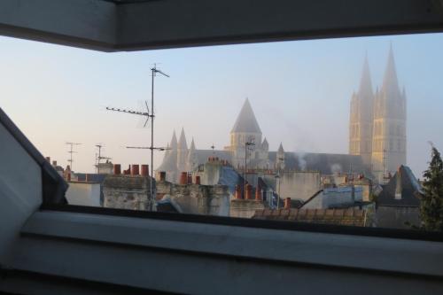 a view of a city from a window at Hotel Saint Etienne in Caen
