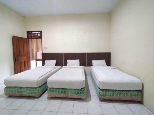 Katil atau katil-katil dalam bilik di Grand Mutiara Hotel Puncak