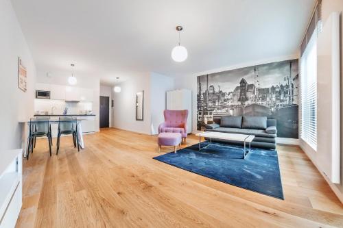 a living room with a couch and a table at VIU Apartament z tarasem w sercu Gdańska in Gdańsk