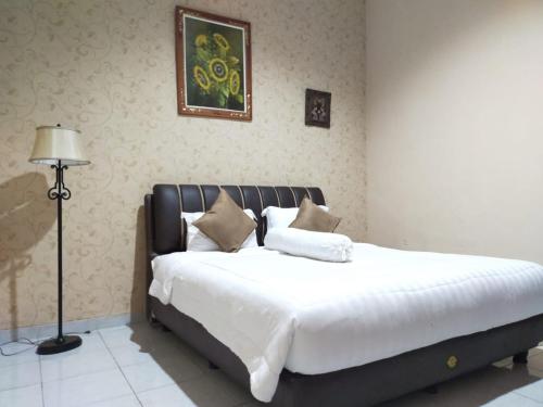Katil atau katil-katil dalam bilik di Grand Mutiara Hotel Puncak