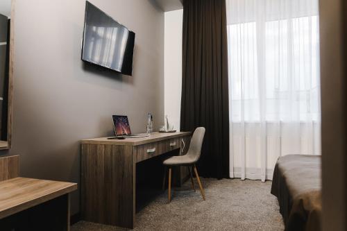 a hotel room with a desk with a laptop on it at Готельно-рестораний комплекс Silver in Ivano-Frankivsʼk