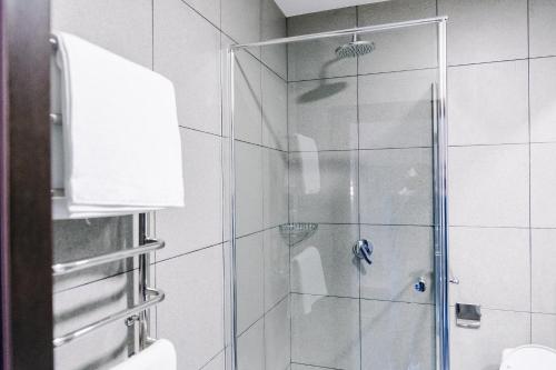 a shower with a glass door in a bathroom at Готельно-рестораний комплекс Silver in Ivano-Frankivsʼk