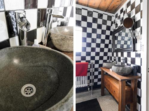a bathroom with a sink and a bathroom with black and white tiles at Mondriaanmolen, a real Windmill close to Amsterdam in Abcoude