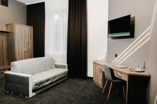 a room with a chair and a desk with a computer at Готельно-рестораний комплекс Silver in Ivano-Frankivsʼk