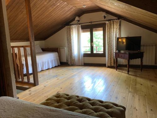 a bedroom with a bed and a television in a room at Hotel Charle in Jaca