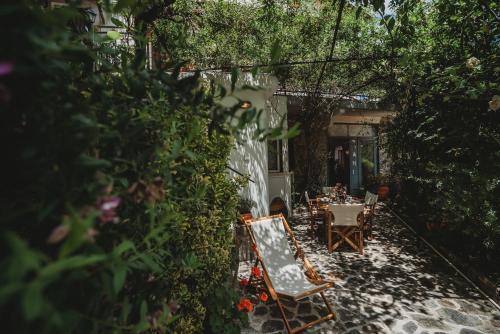 a patio with a table and chairs in a garden at Hani Chrysomilou in Kalopanayiotis