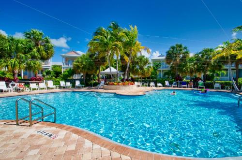 a pool at a resort with palm trees at Angler's Reef Resort in Islamorada