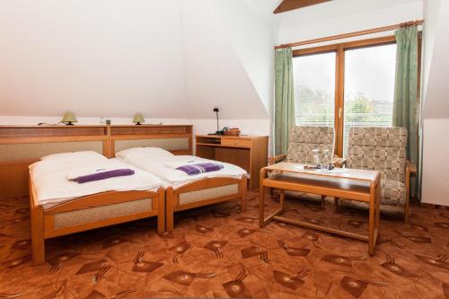 A bed or beds in a room at Depandance Hotel u Crlíků