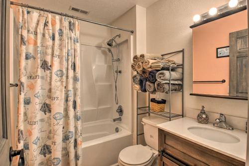 a bathroom with a shower and a toilet and a sink at Riverfront Cottage Fire Pit and Kayaks in Deltaville