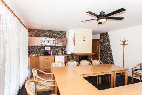 a kitchen and dining room with a table and chairs at Depandance Hotel u Crlíků in Tetčice