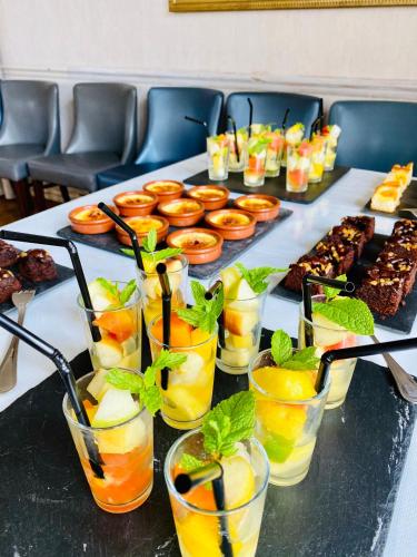 a table with a bunch of drinks in glasses at Le Cheval Blanc in Jargeau