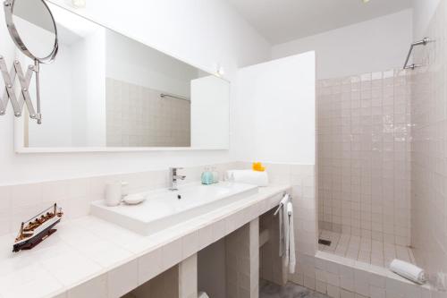 a white bathroom with a sink and a shower at Villa 34 in Corralejo