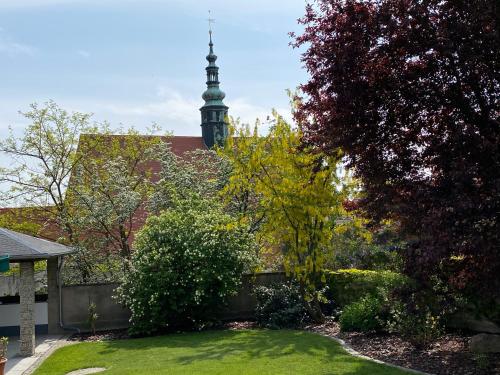 a garden with a clock tower in the background at Ferienwohnung Klosterblick in der Oberlausitz in Panschwitz-Kuckau