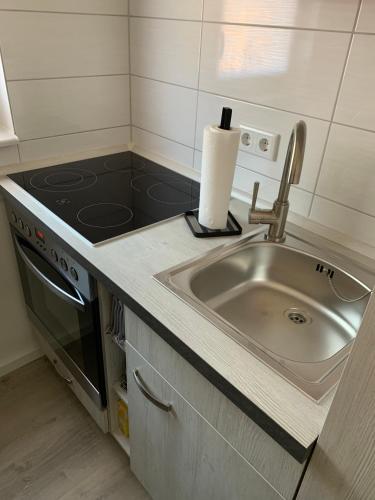 a kitchen with a sink and a stove at Ferienwohnung Blume in Schwielowsee